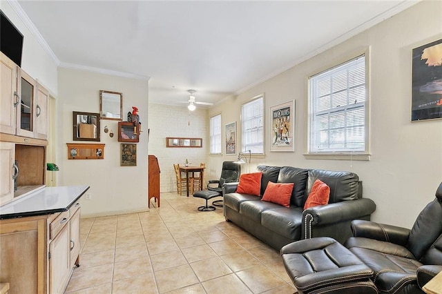 living room with crown molding, light tile patterned floors, and ceiling fan