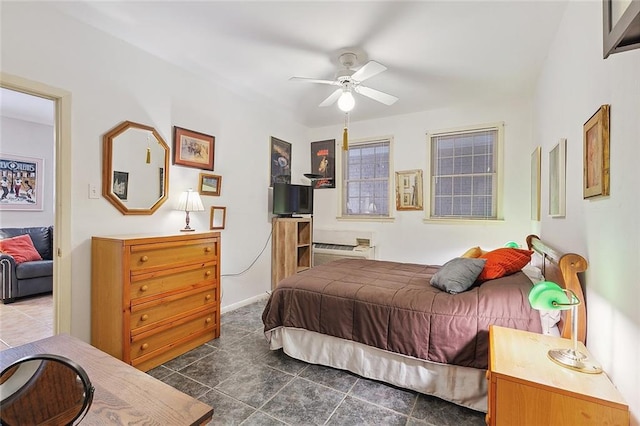 tiled bedroom featuring ceiling fan