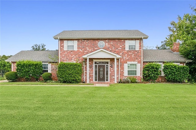 colonial-style house with a front lawn