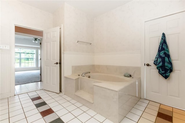 bathroom with ceiling fan, a bathtub, and tile patterned floors