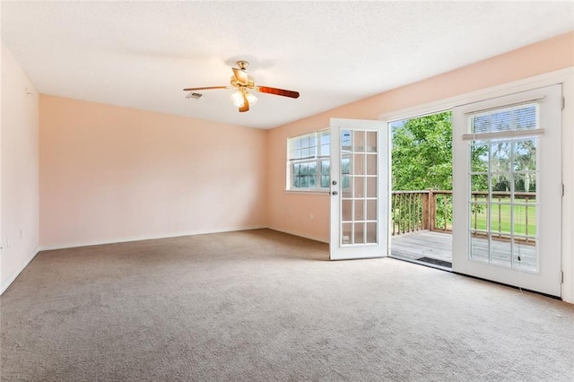 carpeted empty room featuring ceiling fan and french doors