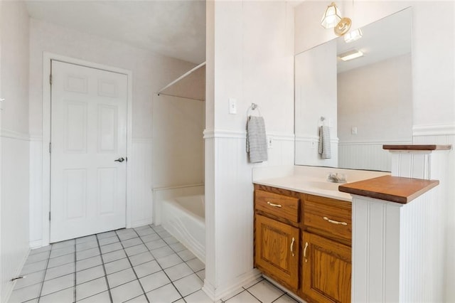 bathroom with tub / shower combination, tile patterned floors, and vanity