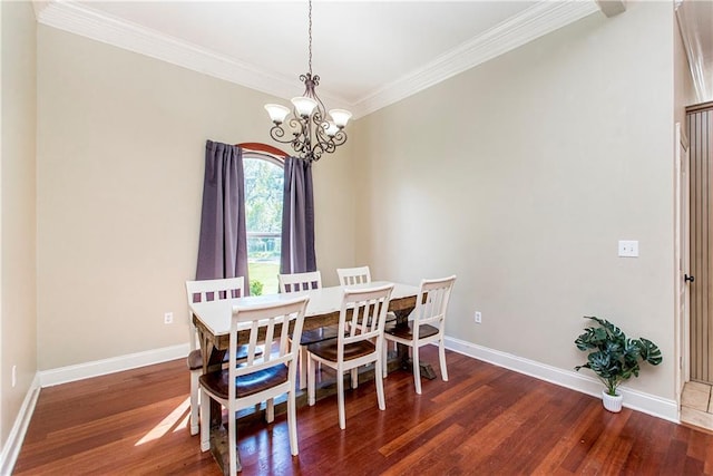 dining area featuring ornamental molding, an inviting chandelier, and dark wood-type flooring