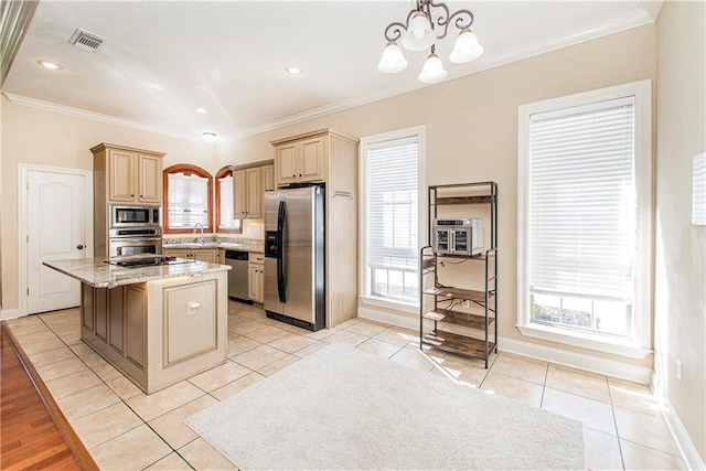 kitchen with plenty of natural light, hanging light fixtures, a center island, and stainless steel appliances