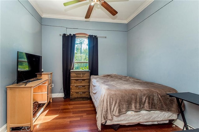 bedroom featuring dark wood-type flooring, ornamental molding, and ceiling fan