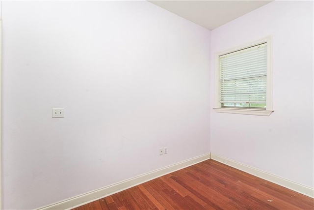 unfurnished room featuring dark wood-type flooring