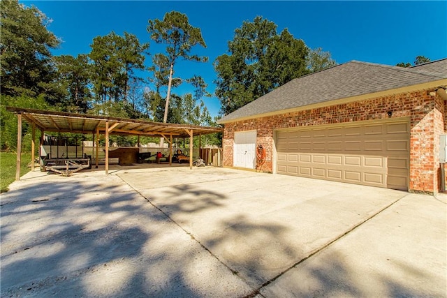 view of home's exterior with a carport and a garage