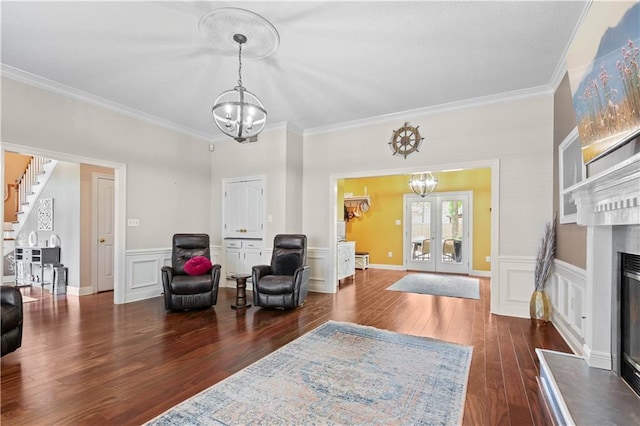 interior space with ornamental molding, dark wood-type flooring, french doors, and an inviting chandelier