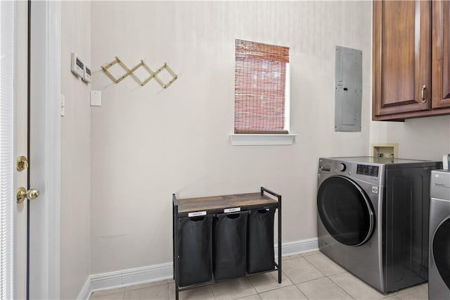 laundry room with electric panel, washer / dryer, light tile patterned floors, and cabinets