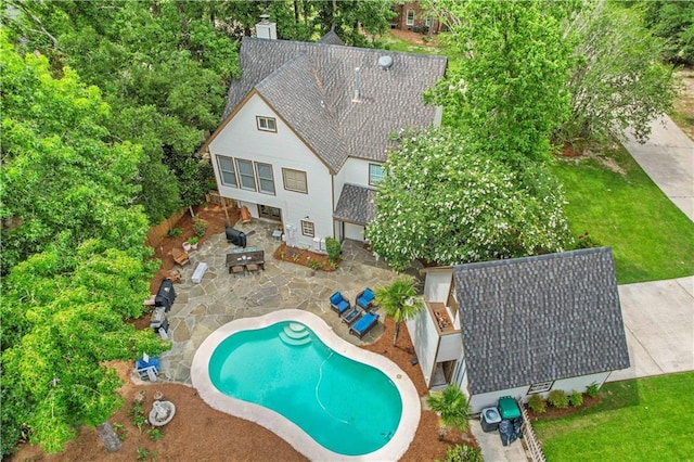 view of pool with a fire pit, a patio, and a yard