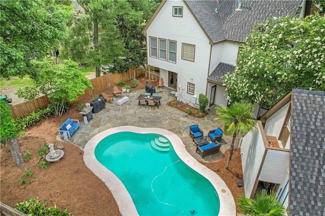 view of swimming pool with a fire pit and a patio area