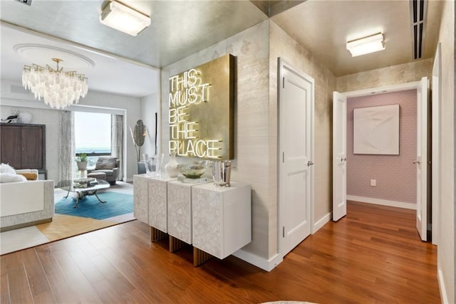 hall with a chandelier and wood-type flooring