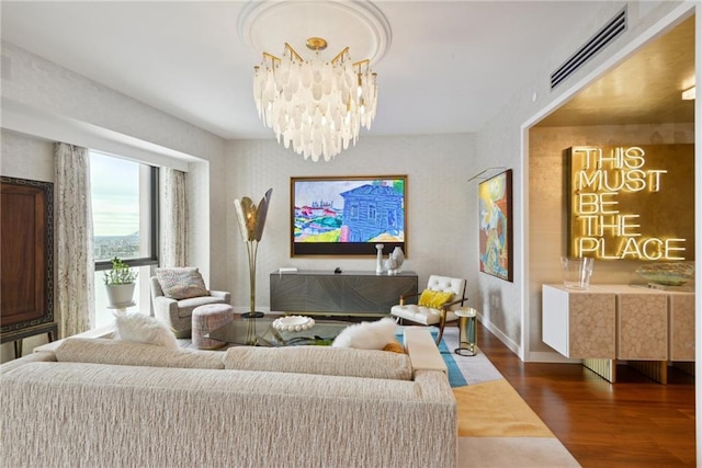 living room with a chandelier and dark hardwood / wood-style floors