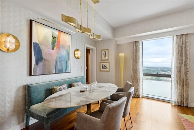 dining area featuring light hardwood / wood-style floors and a baseboard heating unit