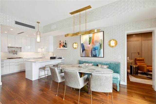 dining room with sink and dark hardwood / wood-style floors