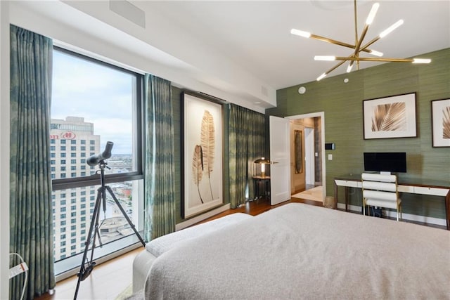 bedroom featuring light hardwood / wood-style flooring and an inviting chandelier