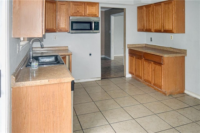 kitchen with light tile patterned flooring and sink