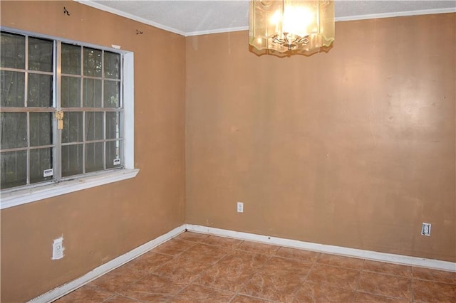 tiled empty room featuring an inviting chandelier and ornamental molding