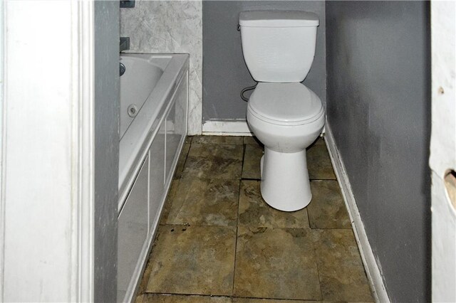 bathroom featuring a tub and toilet