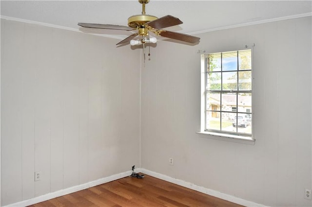 empty room featuring wood-type flooring, ornamental molding, and ceiling fan