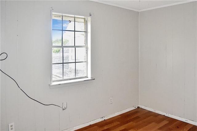 unfurnished room with ornamental molding and hardwood / wood-style floors