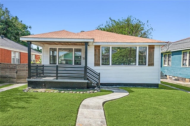 rear view of house featuring a lawn