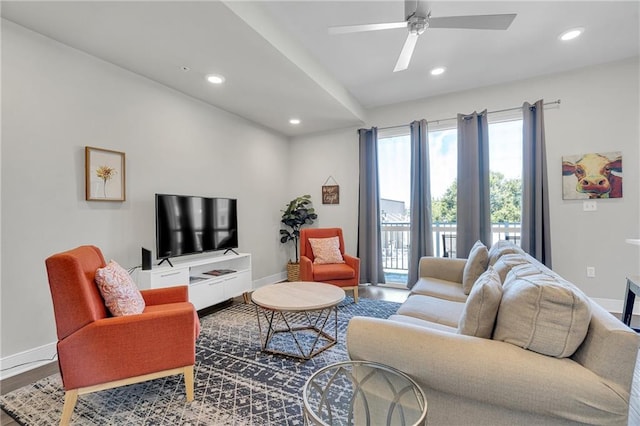 living room featuring ceiling fan and wood-type flooring