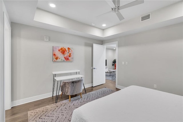 bedroom with ceiling fan and dark hardwood / wood-style floors