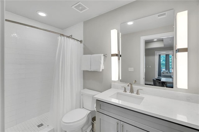 bathroom with a shower with curtain, vanity, and toilet