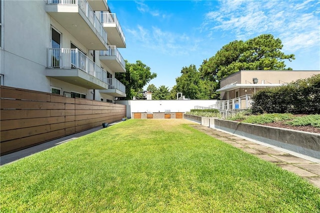 view of yard with a balcony