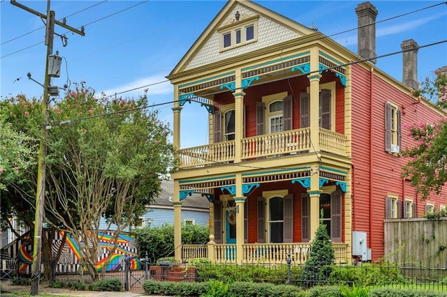 victorian house with a balcony and covered porch