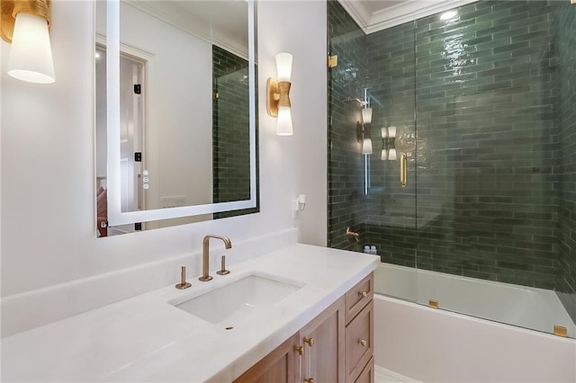 bathroom featuring crown molding, combined bath / shower with glass door, and vanity