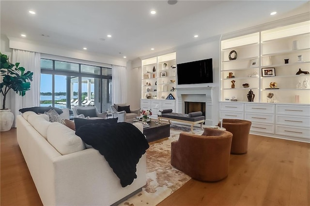 living room featuring built in features and hardwood / wood-style floors