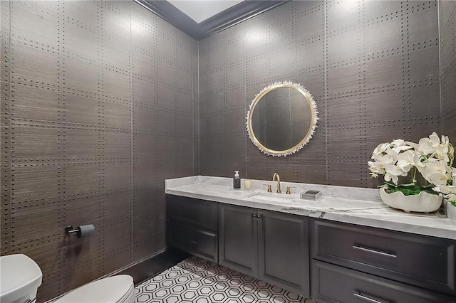 bathroom featuring tile patterned flooring, tile walls, vanity, and toilet