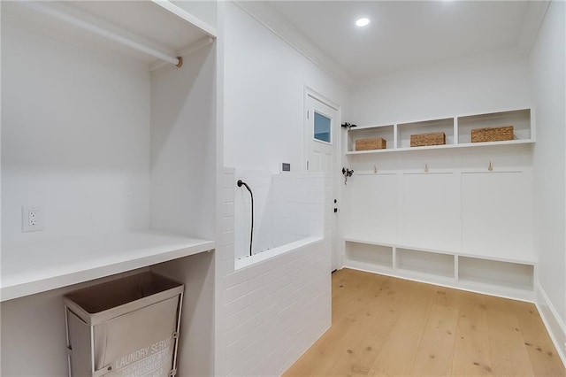 mudroom featuring light wood-type flooring and crown molding