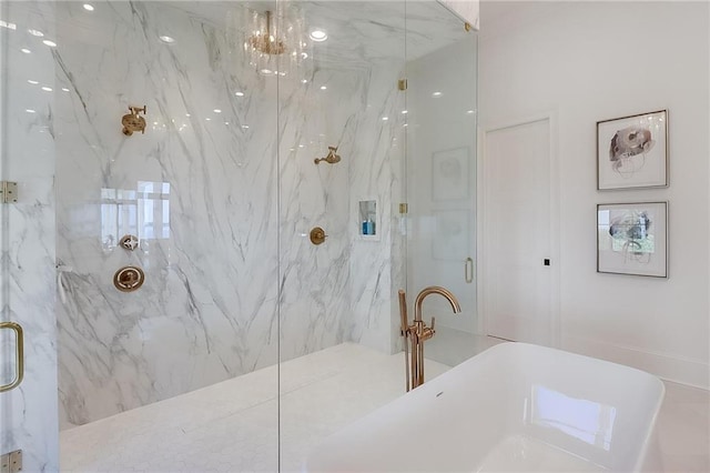 bathroom featuring separate shower and tub and a chandelier