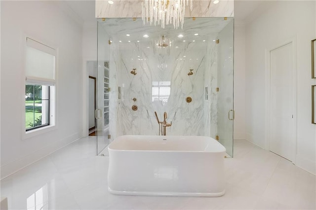 bathroom with tile patterned flooring, a chandelier, and shower with separate bathtub