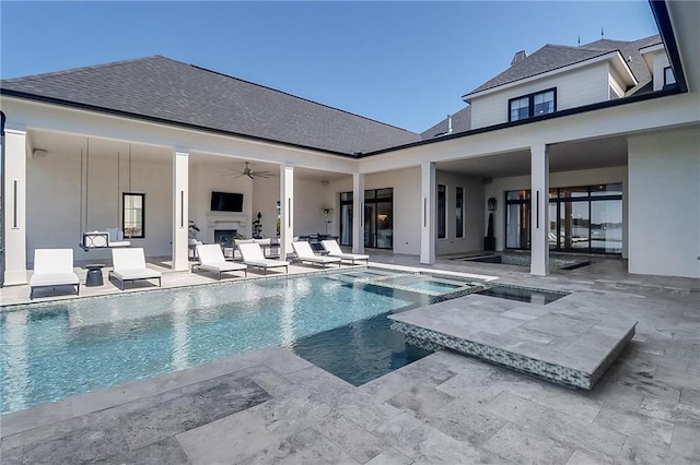 view of swimming pool with an in ground hot tub, a patio, and ceiling fan