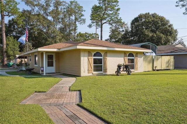 rear view of house with a patio and a lawn