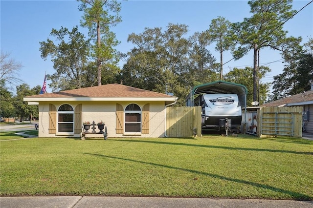 back of property featuring a yard and a carport