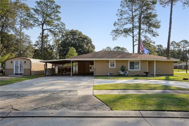 single story home with a front lawn and a carport