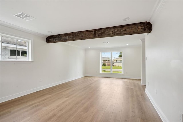 unfurnished room with beamed ceiling, crown molding, and light hardwood / wood-style flooring