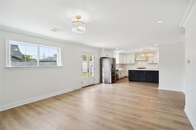 kitchen with white cabinets, light wood-type flooring, hanging light fixtures, and stainless steel fridge with ice dispenser