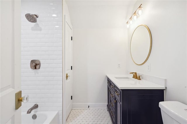 full bathroom with vanity, toilet, and tiled shower / bath