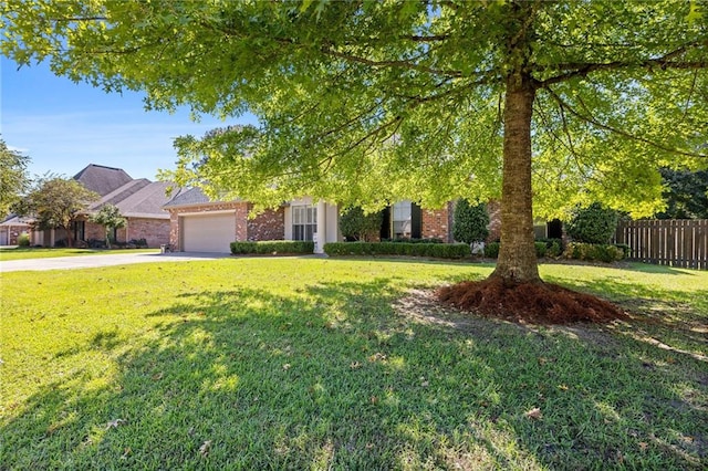 obstructed view of property with a garage and a front lawn