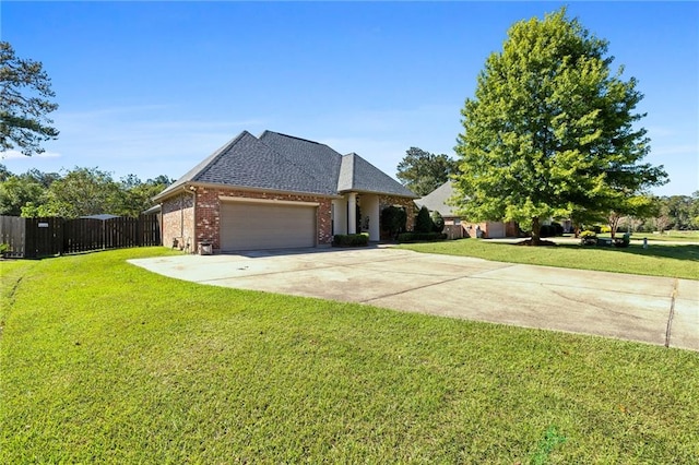 view of front facade with a garage and a front lawn