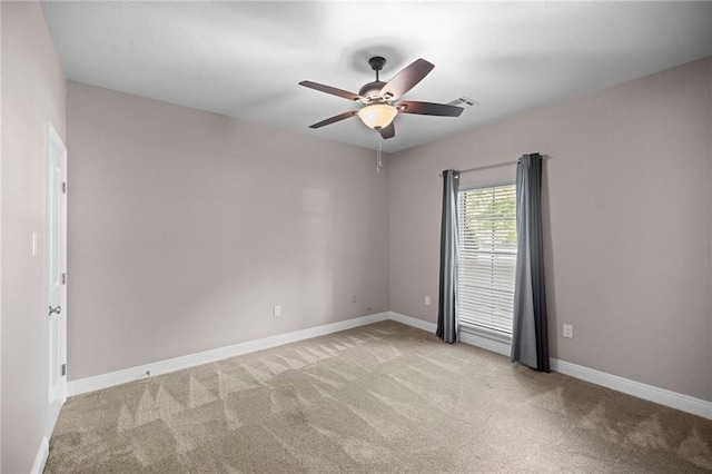 carpeted empty room with ceiling fan