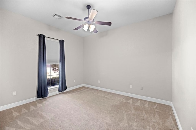 unfurnished room with light colored carpet and ceiling fan