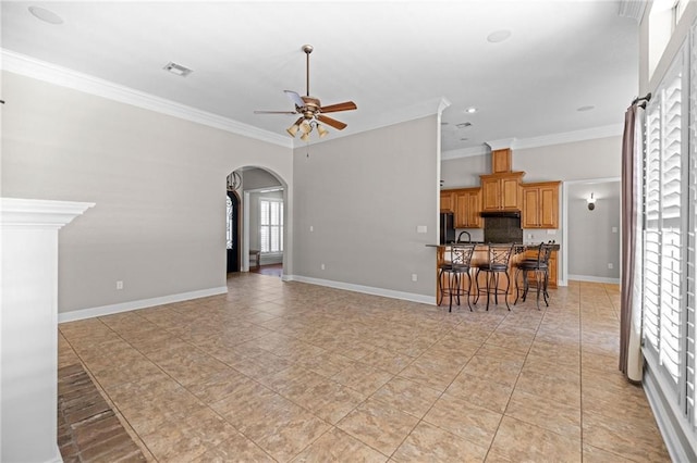 living room with crown molding, light tile patterned floors, and ceiling fan