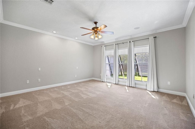 carpeted empty room featuring ceiling fan and crown molding